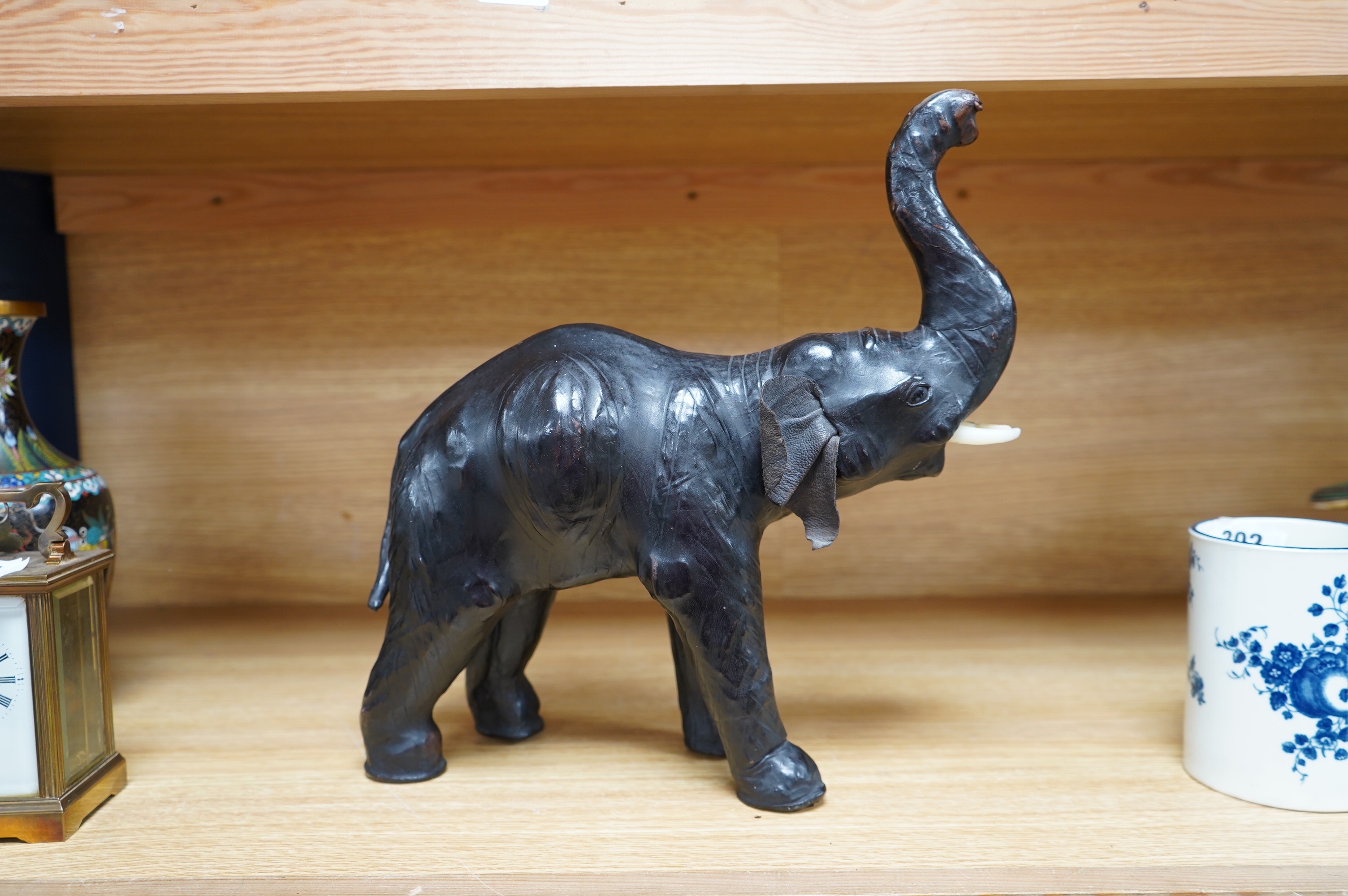 A small leather covered model of an elephant, stamped Liberty, 31cm. Condition - fair